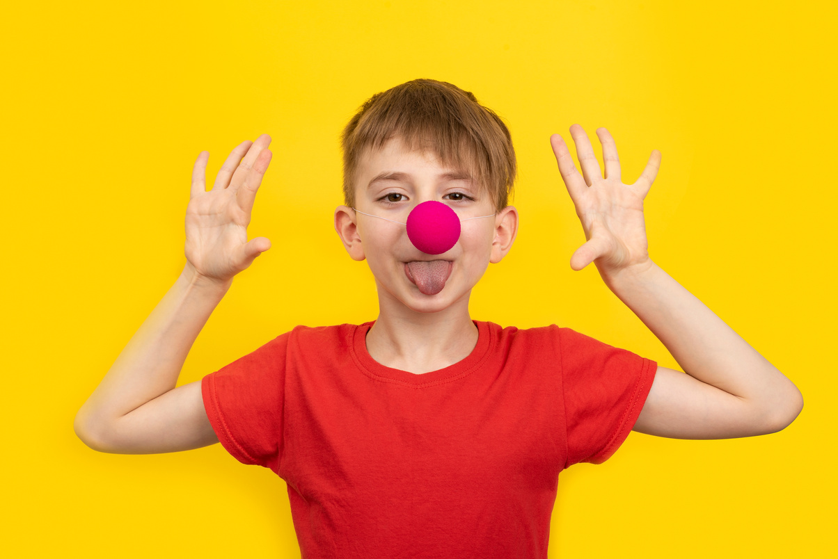 Young Boy Wearing a Red Nose